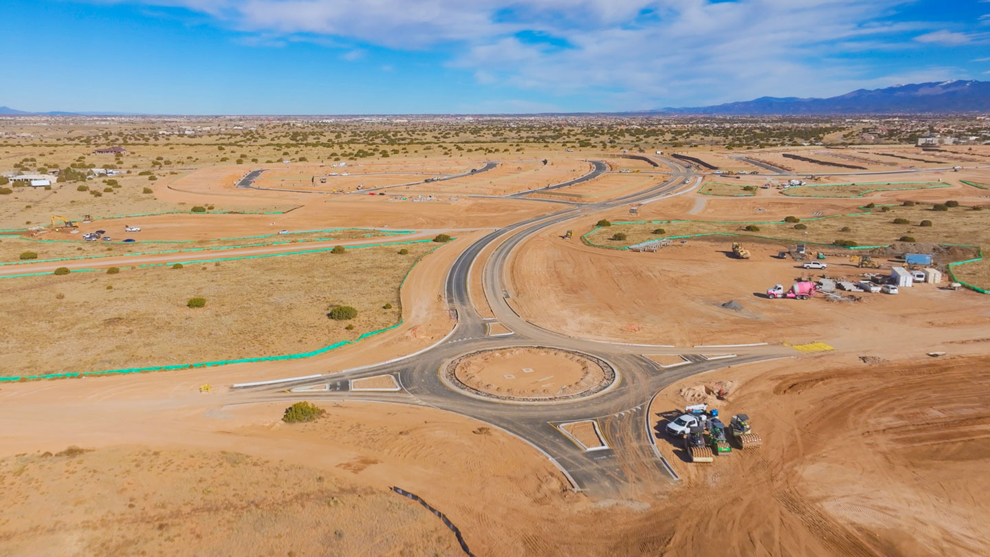 Aerial drone shot of new home community development in Santa Fe New Mexico with graded streets and lots